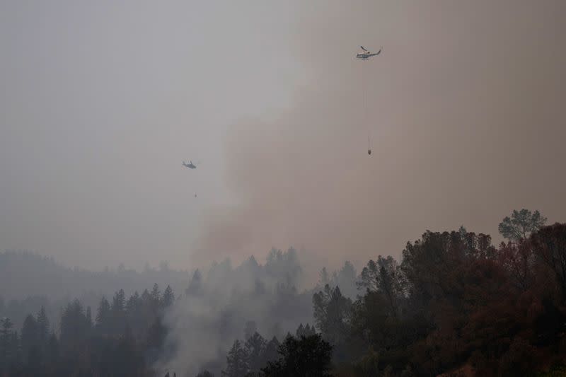 Helicopters prepare to drop water on the Glass Fire in Calistoga, California