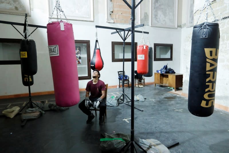 Nico Rodrigues, 21, pauses during a boxing class at the Santa Maria della Sanita Basilica in the Rione Sanita neighbourhood in Naples