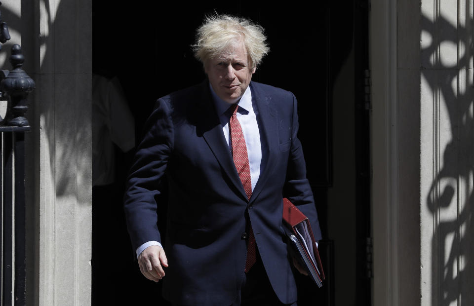 Britain's Prime Minister Boris Johnson leaves Downing Street to attend the weekly session of PMQs in Parliament in London as the country continues its lockdown to help stop the spread of coronavirus, Wednesday, May 20, 2020. (AP Photo/Kirsty Wigglesworth)