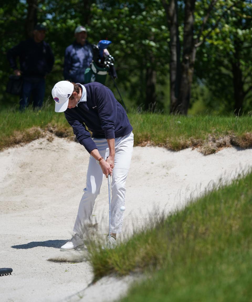 Carmel's Luke O'Grady-Rodgers hits from a fairway bunker on the 10th hole during the Section 1 boys golf championships at Trump National Golf Club-Hudson Valley in Hopewell Junction on Wednesday, May 17, 2023.