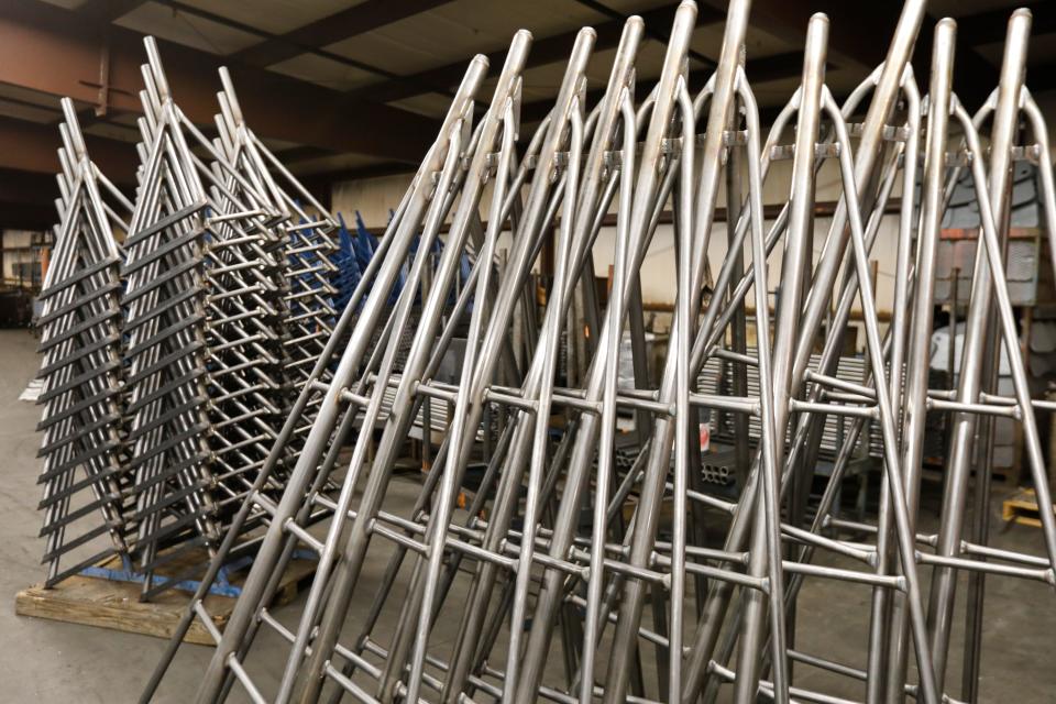 Some of the complete boat stands are stacked before painting at the Brownell Boat Stands manufacturing plant in the Mattapoisett industrial park.