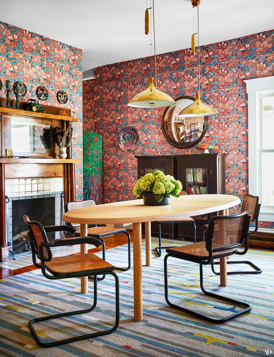 Marcel Breuer chairs surround a Jonathan Muecke table in the dining room. Marthe Armitage hand-blocked wallpaper; Paavo Tynell brass pendants.