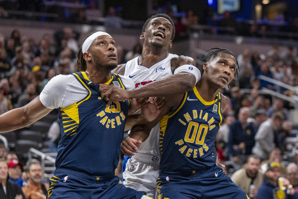 Detroit Pistons center Jalen Duren, center, is boxed out by Indiana Pacers center Myles Turner, left, and guard Bennedict Mathurin (00) during the second half of an NBA basketball game in Indianapolis, Thursday, Feb. 22, 2024. (AP Photo/Doug McSchooler)