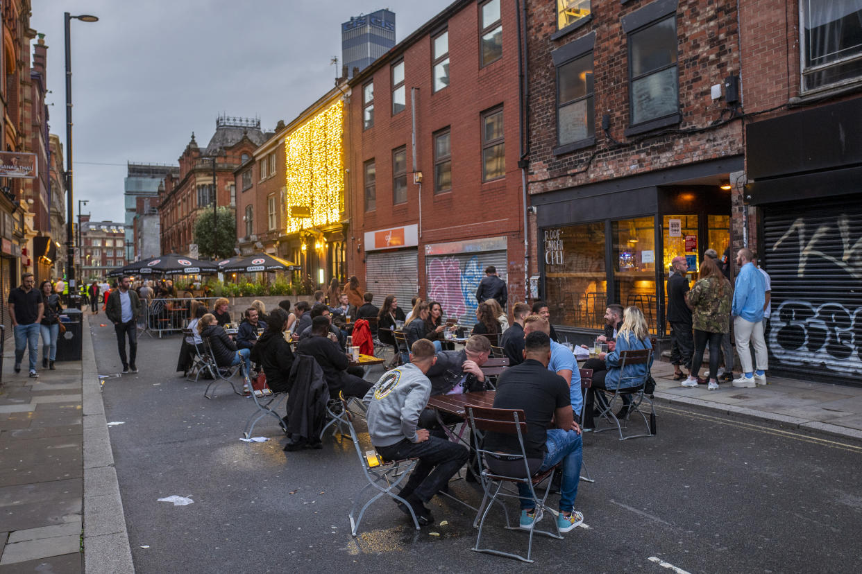 MANCHESTER, ENGLAND - JULY 04: Customers drink outside as bars on Thomas Street in the Northern Quarter set out tables on the closed road on July 04, 2020 in Manchester, England. The UK Government announced that Pubs, Hotels and Restaurants can open from Saturday, July 4th providing they follow guidelines on social distancing and sanitising.  (Photo by Anthony Devlin/Getty Images)