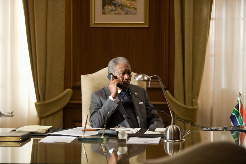 Mandela sitting behind the presidential desk