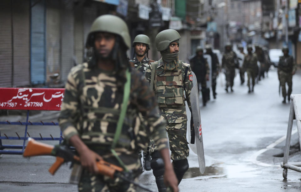 Indian paramilitary soldiers patrol a street in Srinagar, Indian controlled Kashmir, Saturday, Aug. 10, 2019. Authorities enforcing a strict curfew in Indian-administered Kashmir will bring in trucks of essential supplies for an Islamic festival next week, as the divided Himalayan region remained in a lockdown following India's decision to strip it of its constitutional autonomy. The indefinite 24-hour curfew was briefly eased on Friday for weekly Muslim prayers in some parts of Srinagar, the region's main city, but thousands of residents are still forced to stay indoors with shops and most health clinics closed. All communications and the internet remain cut off. (AP Photo/Mukhtar Khan)