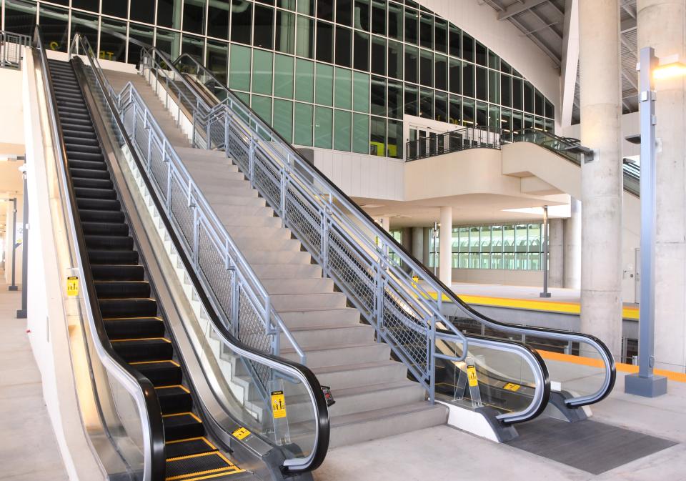 A set of escalators at the three-story Brightline station at Orlando International Airport.