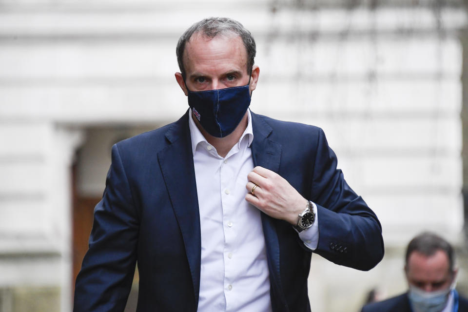 Britain's Foreign Secretary Dominic Raab wears a face mask as he arrives at 10 Downing Street, in London, Wednesday, Feb. 3, 2021.(AP Photo/Alberto Pezzali)