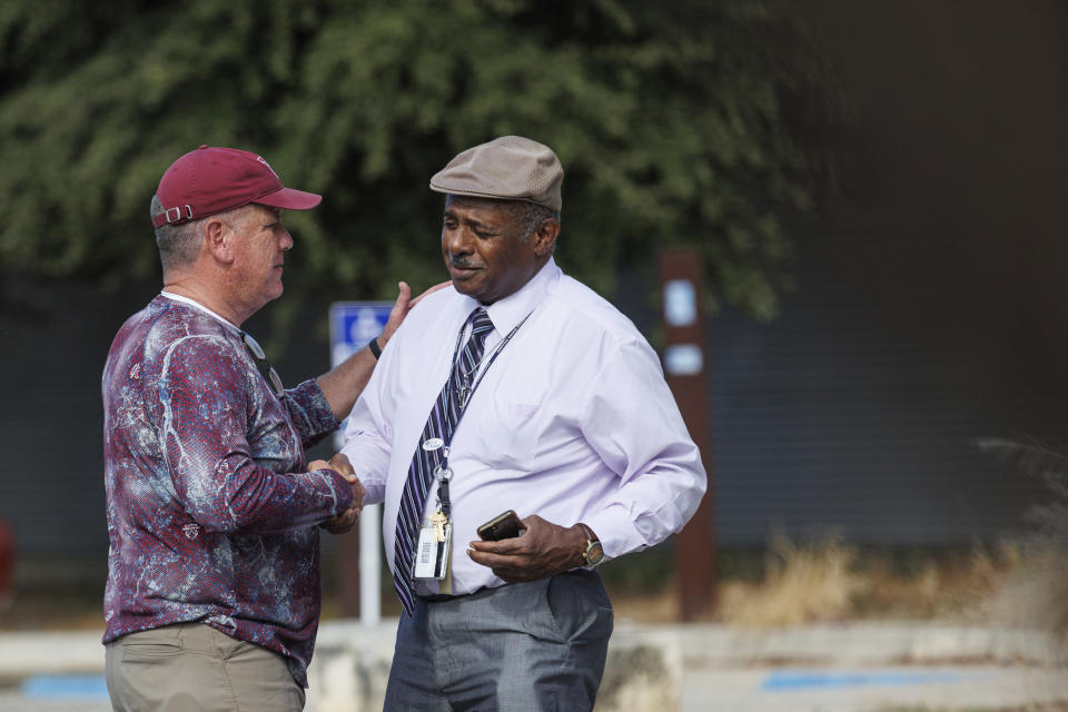 Uvalde mayoral candidate Cody Smith, left, chats with a community member outside of the SSGT Willie de Leon Civic Center, where votes are cast on Election Day, Tuesday, Nov. 7, 2023, in Uvalde, Texas. In Uvalde’s first mayoral race since the Robb Elementary School shooting, Smith won back the job Tuesday over Kimberly Mata-Rubio, a mother who has led calls for tougher gun laws since her daughter was among the 19 children killed in the 2022 attack. (Sam Owens/The San Antonio Express-News via AP)