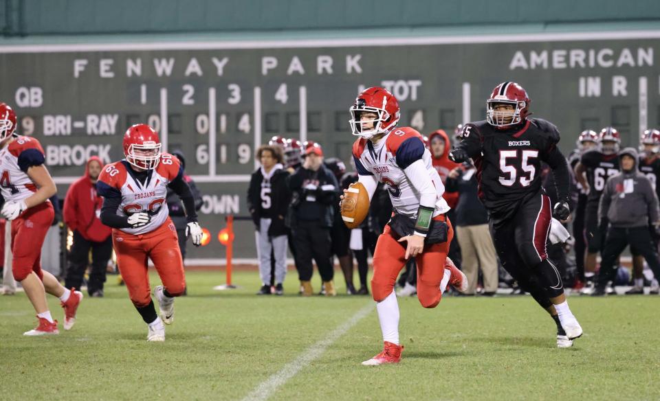 Bridgewater-Raynham quarterback Declan Byrne carries the football during a game versus Brockton at Fenway Park on Wednesday, Nov. 23, 2022.      