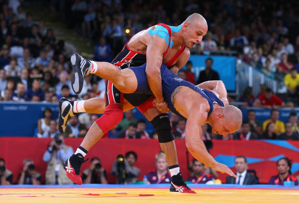 LONDON, ENGLAND - AUGUST 06: Damian Janikowski of Poland (R) competes with Karam Mohamed Gaber Ebrahim of Egypt during their Men's Greco-Roman 84 kg Wrestling Semi Final on Day 10 of the London 2012 Olympic Games at ExCeL on August 6, 2012 in London, England. (Photo by Cameron Spencer/Getty Images)