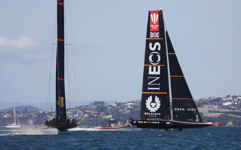 Britain's INEOS Team UK, right, leads Italy's Luna Rossa to win race six of the Prada Cup on Auckland's Waitemata Harbour, New Zealand, Saturday, Feb. 20, 2021. (Dean Purcell/NZ Herald via AP)