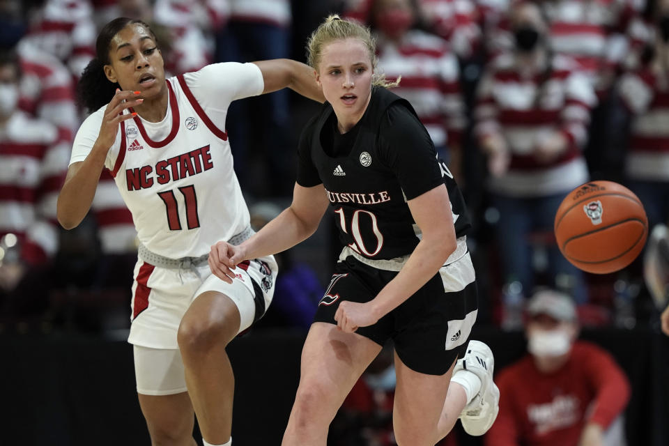 North Carolina State forward Jakia Brown-Turner (11) and Louisville guard Hailey Van Lith (10) chase the ball during the second half of an NCAA college basketball game in Raleigh, N.C., Thursday, Jan. 20, 2022. (AP Photo/Gerry Broome)