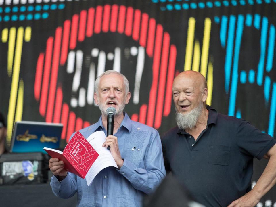 Jeremy Corbyn with Glastonbury founder Michael Eavis on the festival’s main stage on Saturday (Getty)