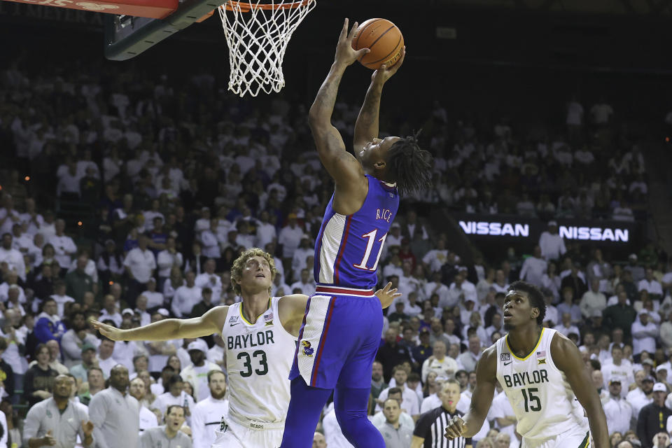 Kansas guard MJ Rice (11) scores over Baylor forward Caleb Lohner (33) during the first half of an NCAA college basketball game Monday, Jan. 23, 2023, in Waco, Texas. (AP Photo/Jerry Larson)