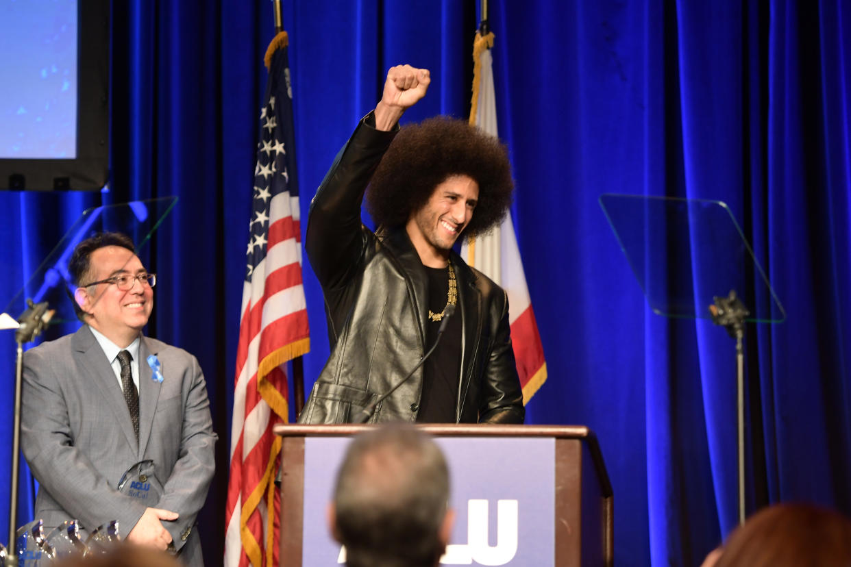 Colin Kaepernick raises his right first at the ACLU SoCal’s annual Bill of Rights Dinner on Sunday in Beverly Hills. (Getty Images)