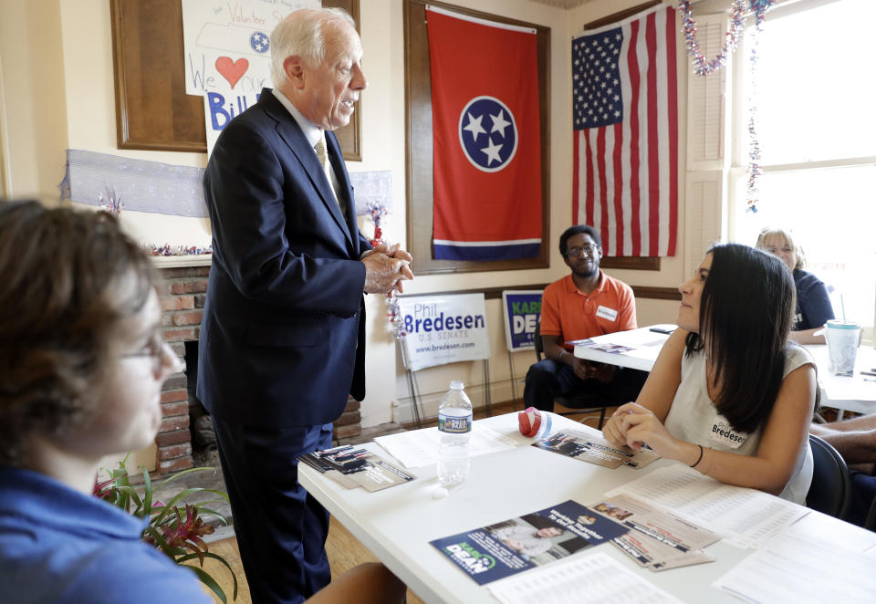 In this Sept. 19, 2018, photo, former Tennessee Democratic Gov. Phil Bredesen, second from left, talks with workers in his campaign headquarters in Nashville, Tenn. Bredesen is a Democrat. But he'd rather you not mention that. So far his strategy of trying to maintain "independence from all of the national Democratic stuff" is working for the two-term Tennessee governor now running for Senate. (AP Photo/Mark Humphrey)