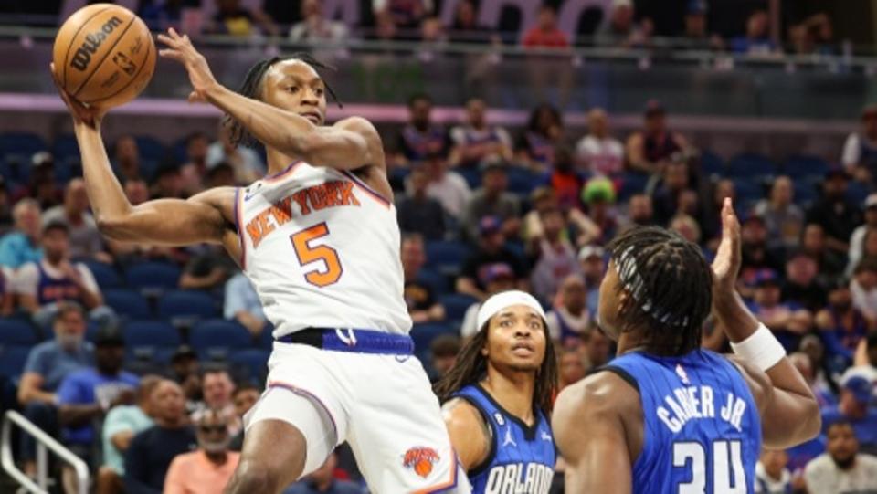 New York Knicks guard Immanuel Quickley (5) passes the ball over Orlando Magic center Wendell Carter Jr.  (34) in the first quarter at Amway Center