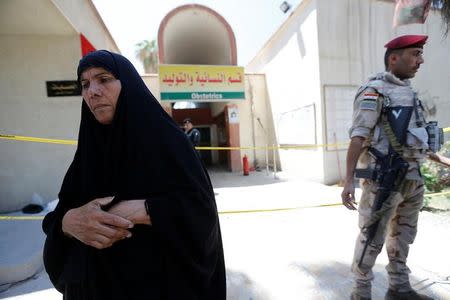 An Iraqi woman stands in front of a maternity ward after a fire broke out at Yarmouk hospital in Baghdad, Iraq, August 10, 2016. REUTERS/Thaier Al-Sudani