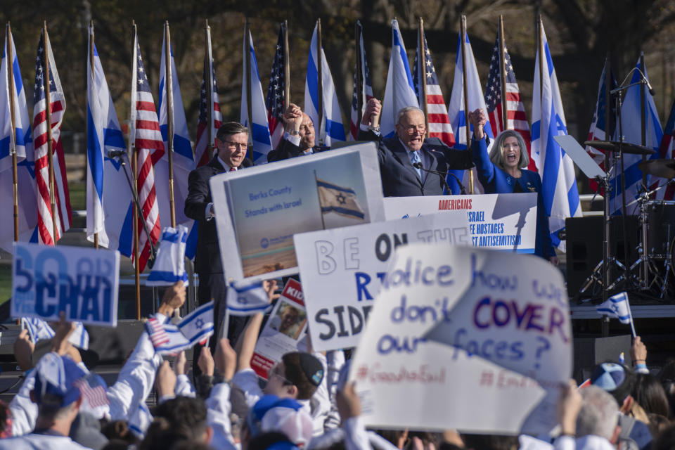 House Speaker Mike Johnson, of La., from left, House Minority Leader Hakeem Jeffries, D-N.Y., Senate Majority Leader Chuck Schumer of N.Y., and Sen. Joni Ernst, R-Iowa join a March for Israel rally on the National Mall in Washington, Tuesday, Nov. 14, 2023. (AP Photo/Manuel Balce Ceneta)