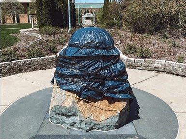 sculpture covered in tarp michigan coronavirus