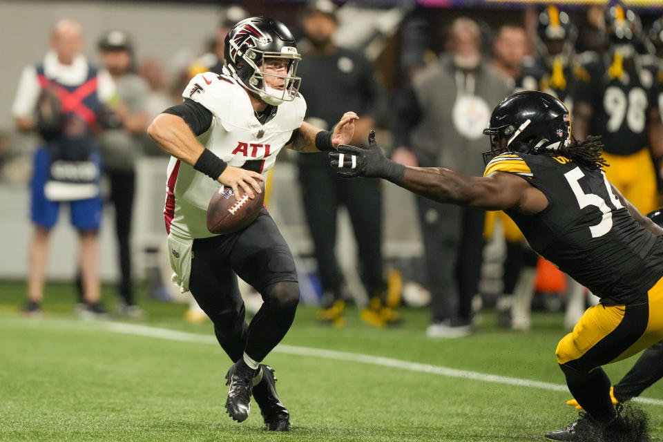 Atlanta Falcons quarterback Taylor Heinicke looks to pass under pressure from Pittsburgh Steelers linebacker Markus Golden during the first half of a preseason NFL football game Thursday, Aug. 24, 2023, in Atlanta. (AP Photo/Gerald Herbert)