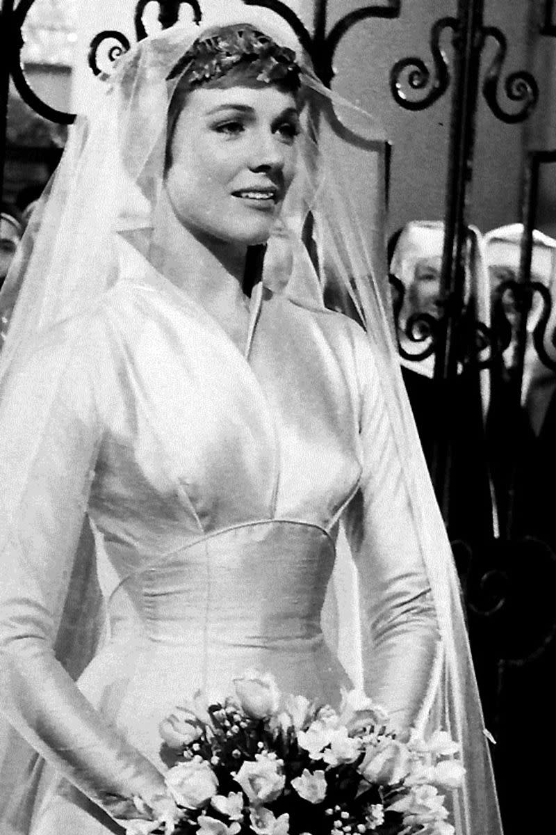 <p>For the first half of <em>The</em> <em>Sound of Music</em><em>,</em> we see Maria, played by Julie Andrews, only in her uniform. But we're treated to an elegant structured satin gown, elaborate headpiece, and simple veil in the second half when her sisters give her away to Captain Von Trapp.</p>