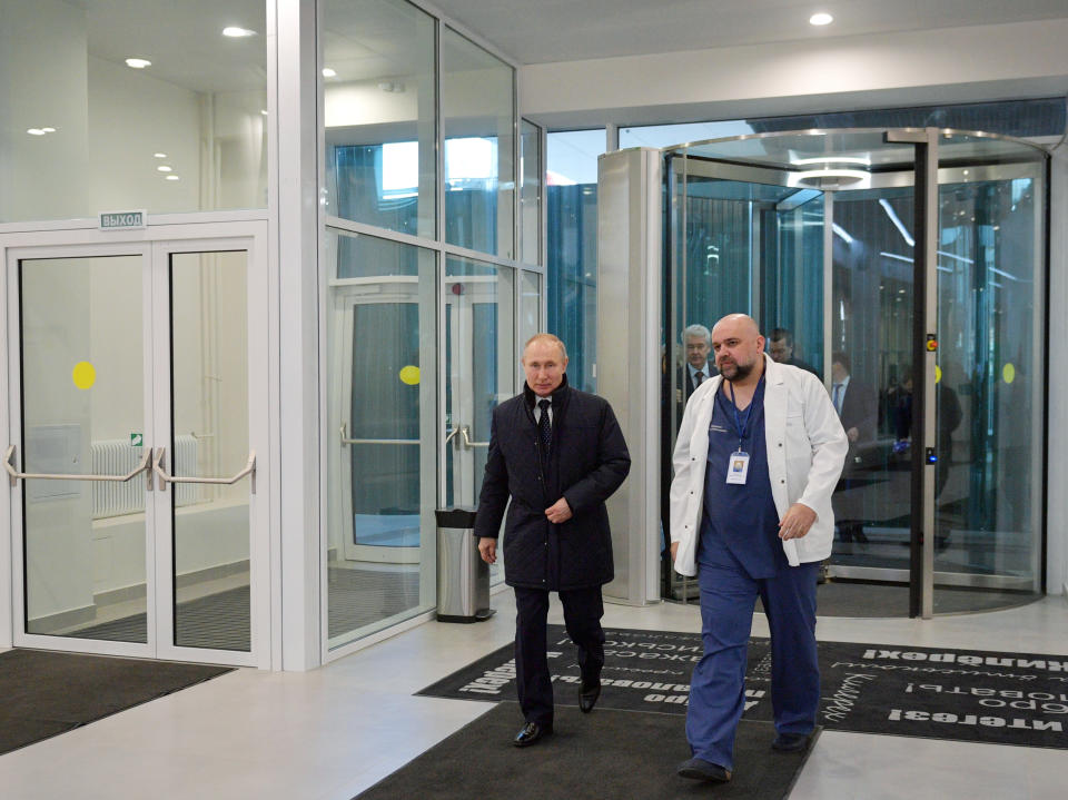 Russian President Vladimir Putin, left, and the hospital's chief Denis Protsenko enter the hall of the hospital for coronavirus patients in Kommunarka settlement, outside Moscow, Russia, Tuesday, March 24, 2020. During a visit to the Komunarka hospital on Moscow outskirts, Putin praised its doctors for high professionalism, saying they were working "like clockwork." (Alexei Druzhinin, Sputnik, Kremlin Pool Photo via AP)