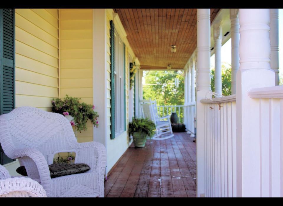 White wicker chairs brighten up this rustic porch.    Photo by Flickr user <a href="http://www.flickr.com/photos/douggarner/3037211014/" target="_hplink">douggarner08.</a> 