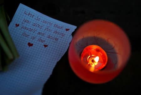 A handwritten note is left following a candlelit vigil in memory of the victims of the gay nightclub mass shooting in Orlando, outside St Georges Hall in Liverpool, northern England, June 13, 2016. REUTERS/Phil Nobe