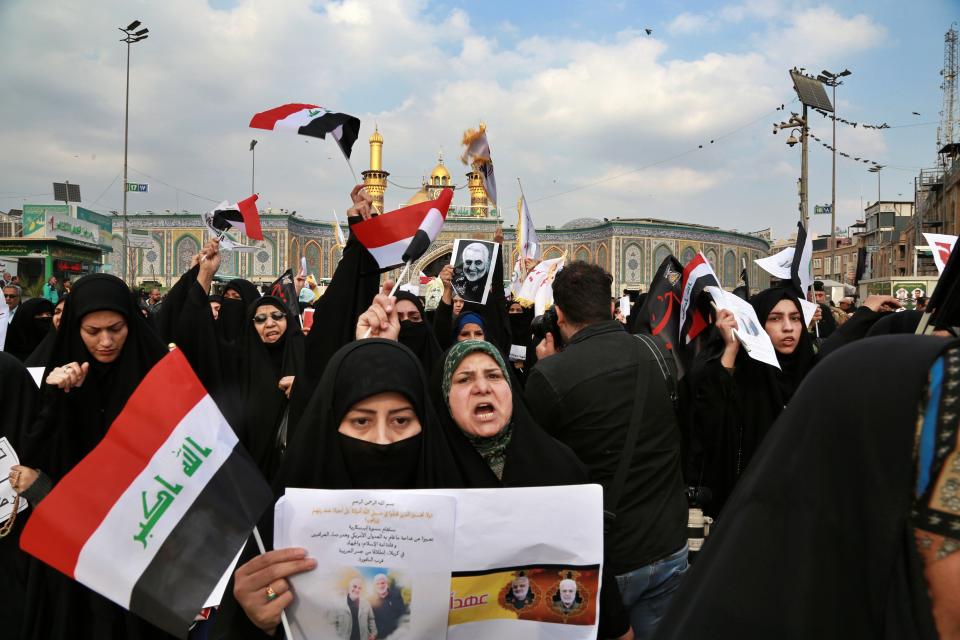 Shiite Muslims demonstrate over the U.S. airstrike that killed Iranian Revolutionary Guard Gen. Qassem Soleimani, in the posters, in Karbala, Iraq, Saturday, Jan. 4, 2020. Iran has vowed "harsh retaliation" for the U.S. airstrike near Baghdad's airport that killed Tehran's top general and the architect of its interventions across the Middle East, as tensions soared in the wake of the targeted killing. (AP Photo/Khalid Mohammed)