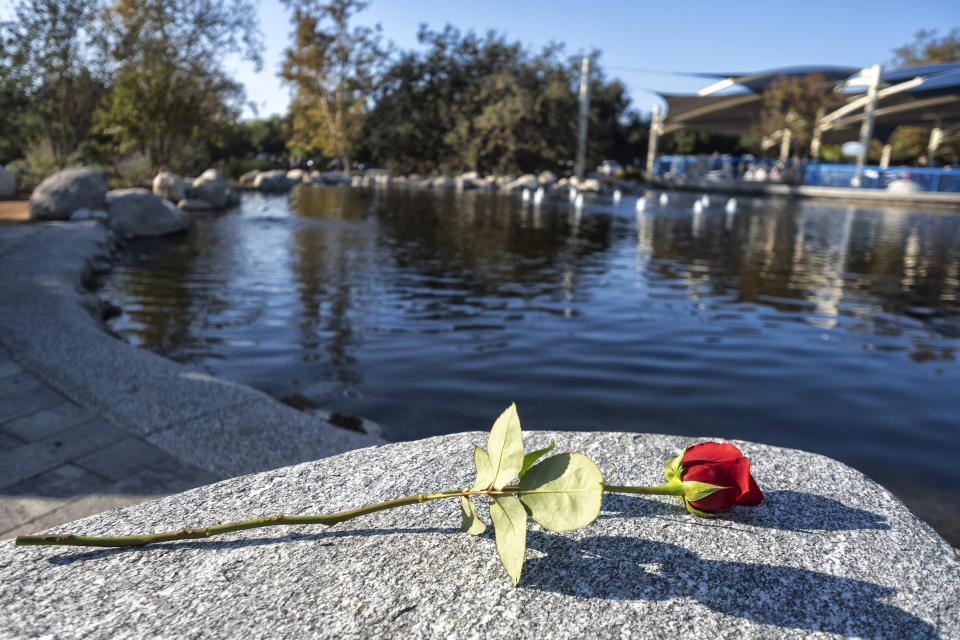 A rose rests on a stone of the Borderline Healing Garden at Conejo Creek Park in Thousand Oaks, Calif., Thursday, Nov. 7, 2019. A dedication ceremony marked the anniversary of a fatal mass shooting at a country-western bar a year earlier. (Hans Gutknecht/The Orange County Register via AP)