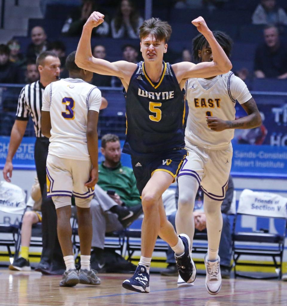 Wayne's Cameron Blankenberg celebrates after his dunk in the second half put the Eagles up over East during their boys basketball Section V Class A sectional final game Saturday, March 2, 2024 at the Blue Cross Arena in Rochester. Wayne won the final 48-42.