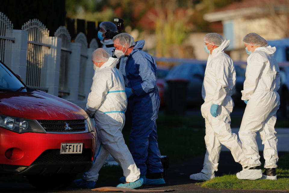 New Zealand police investigators work at a scene in Auckland on Aug. 11, 2022, after bodies were discovered in suitcases. A family who bought some abandoned goods from a storage unit in an online auction found the bodies of two young children concealed in two suitcases, police said Thursday, Aug. 18, 2022. (Dean Purcell/New Zealand Herald via AP)