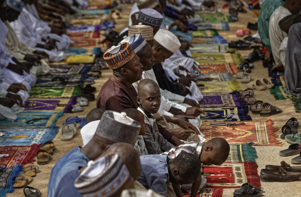 Muslims make traditional Friday prayers at a mosque near to the Emir's palace in Kano, northern Nigeria Friday, Feb. 15, 2019. Nigeria is due to hold general elections on Saturday, pitting incumbent President Muhammadu Buhari against leading opposition presidential candidate Atiku Abubakar. (AP Photo/Ben Curtis)