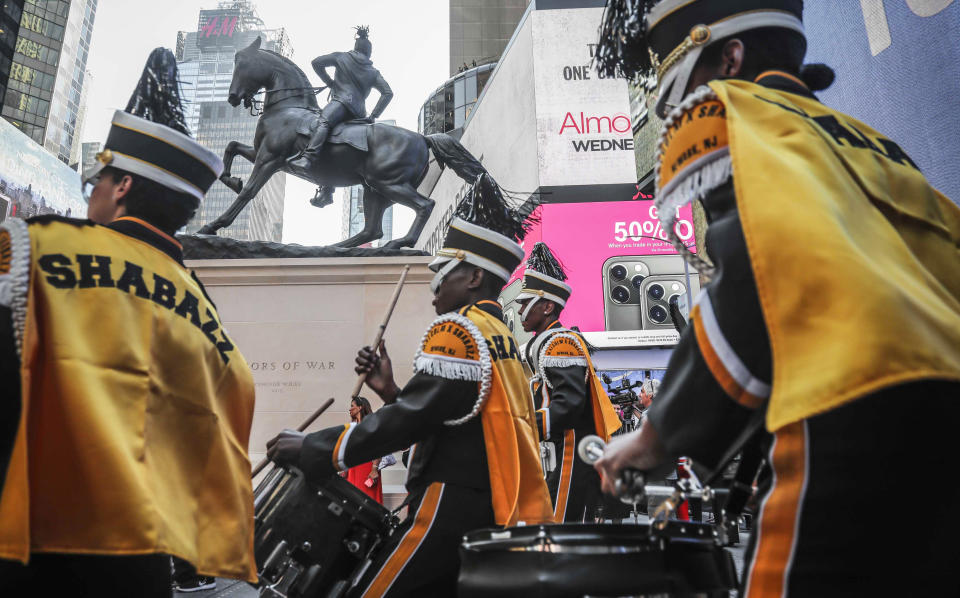 Members of the Malcom Shabazz High School marching band, from Newark, N.J., perform at the the unveiling of artist Kehinde Wiley's sculpture "Rumors of War" on Friday Sept. 27, 2019, in New York. The work, depicting of a young African American in urban streetwear sitting astride a galloping horse, will be exhibited through December 1. (AP Photo/Bebeto Matthews)