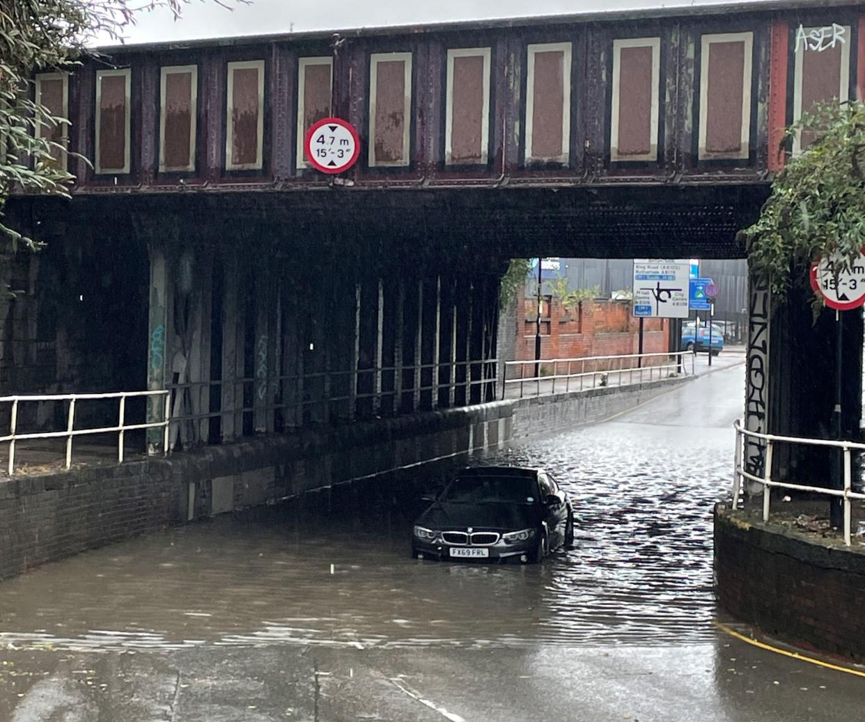 File photo: A car stuck in floodwater under a railway bridge at Upwell Street, Sheffield (PA)