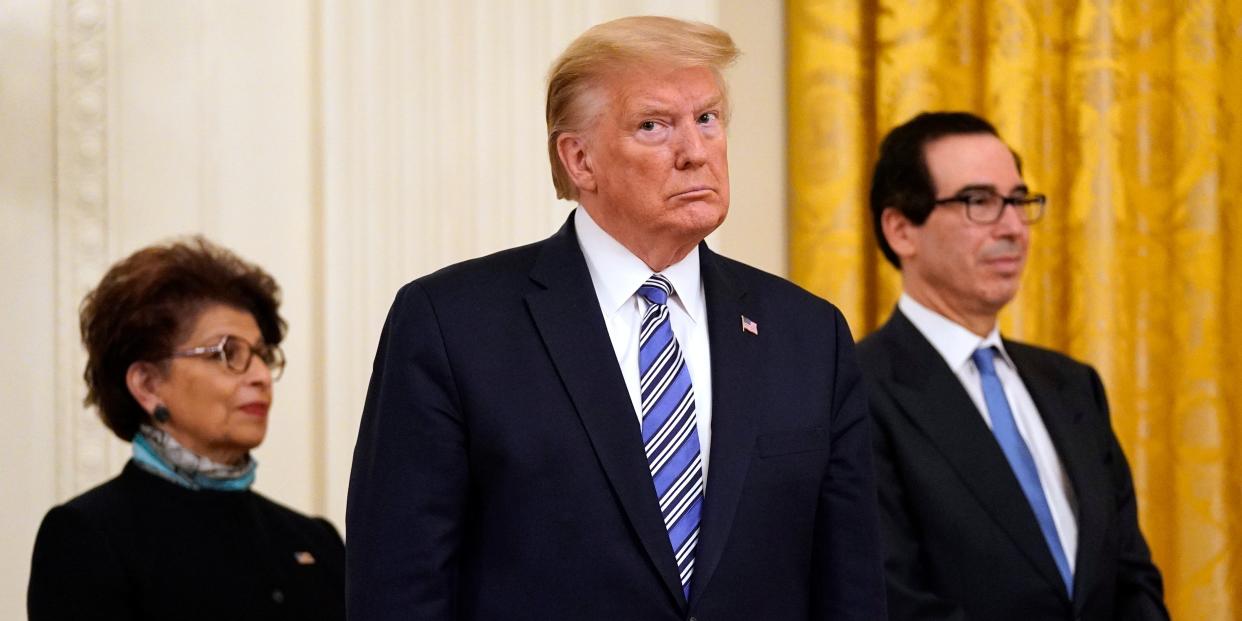 FILE - In this April 28, 2020 file photo President Donald Trump, along with Jovita Carranza, administrator of the Small Business Administration, and Treasury Secretary Steven Mnuchin listen during an event about the Paycheck Protection Program used to support small businesses during the coronavirus outbreak, in the East Room of the White House in Washington. The Small Business Administration is shouldering a massive relief effort for the nation’s small businesses and their workers left reeling by the pandemic. The agency has committed to auditing every sizable emergency loan it approves. But six weeks after the $600 billion-plus program was launched, the agency has yet to make public the recipients of taxpayer aid.  (AP Photo/Evan Vucci)