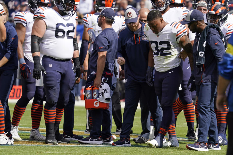 Chicago Bears running back David Montgomery (32) is helped off the field during the first half of an NFL football game against the Houston Texans Sunday, Sept. 25, 2022, in Chicago. (AP Photo/Nam Y. Huh)