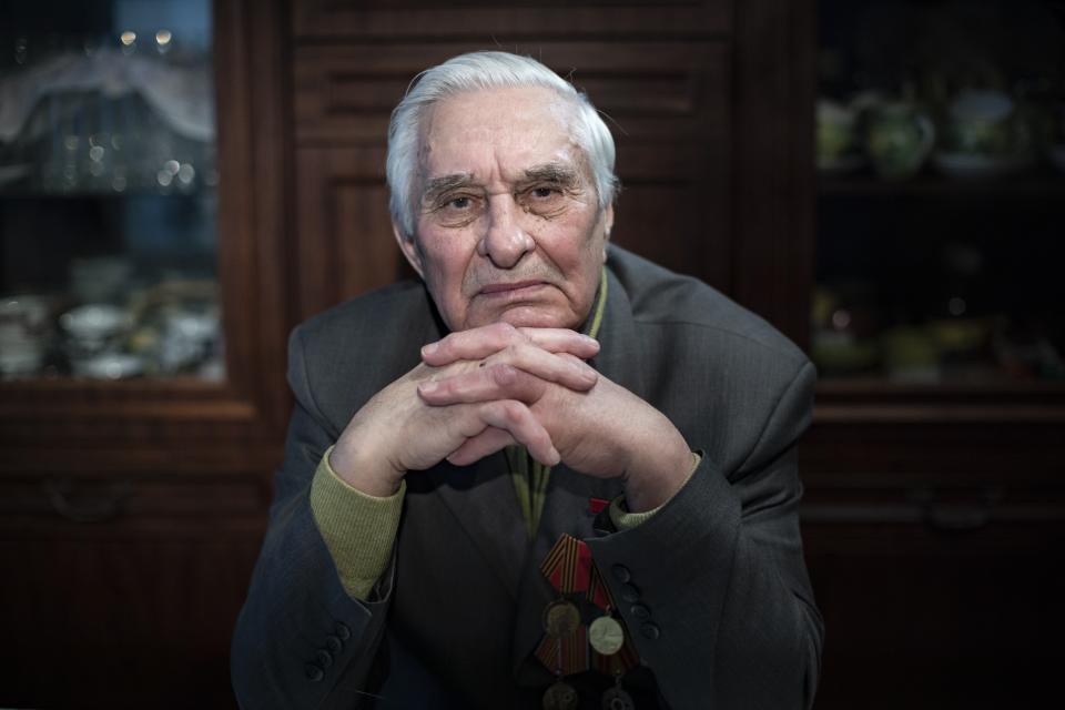 In this photo taken on Monday, Jan. 20, 2020, Yevgeny Kovalev, one of the Auschwitz concentration camp's survivors, poses for a photo during an interview with the Associated Press at his flat in Moscow, Russia. Kovalev was arrested by the Nazis as a teenager and sent to the Auschwitz death camp is still amazed 75 years later that he survived the ordeal. The 92-year-old was speaking ahead of the 75th anniversary on Monday, Jan. 27, 2020 of the camp's liberation in 1945. (AP Photo/Alexander Zemlianichenko)