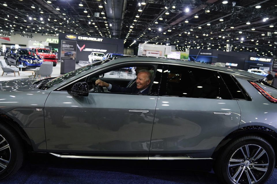 FILE - President Joe Biden drives a Cadillac Lyriq through the show room during a tour at the Detroit Auto Show Sept. 14, 2022, in Detroit. (AP Photo/Evan Vucci, File)
