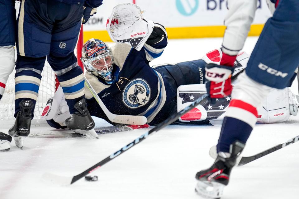 Jan 5, 2023; Columbus, Ohio, USA;  Columbus Blue Jackets goaltender Elvis Merzlikins (90) guards the goal from Washington Capitals center Aliaksei Protas (59) during the second period of the NHL game between the Columbus Blue Jackets and the Washington Capitals on Thursday night at Nationwide Arena. Mandatory Credit: Joseph Scheller-The Columbus Dispatch