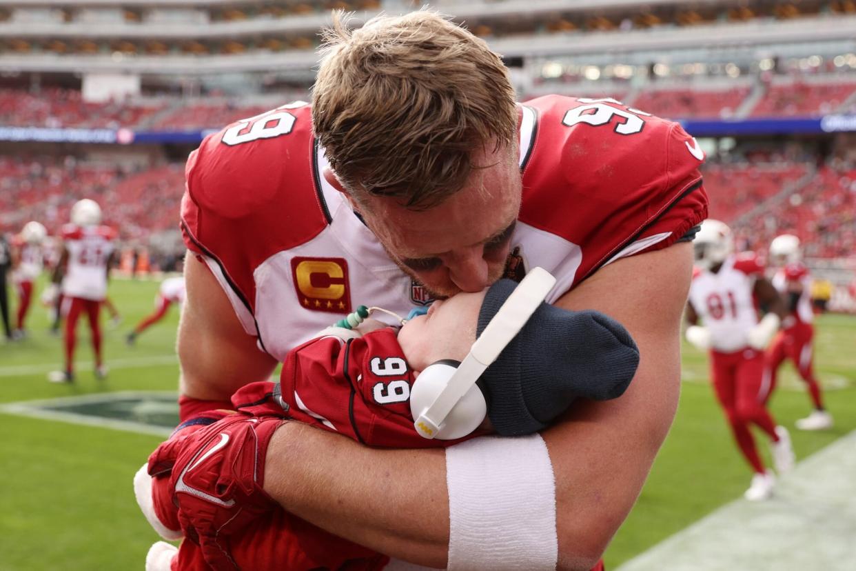 SANTA CLARA, CALIFORNIA - JANUARY 08: J.J. Watt #99 of the Arizona Cardinals gives his son Koa Watt a kiss prior to the game against the San Francisco 49ers at Levi's Stadium on January 08, 2023 in Santa Clara, California. (Photo by Ezra Shaw/Getty Images)