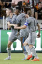 From left to right, CF Montreal's Lassi Lappalainen, Romell Quioto and Samuel Piette celebrate a goal by Lappalainen against the Houston Dynamo during the second half of an MLS soccer match Saturday, Aug. 13, 2022, in Houston. (AP Photo/Michael Wyke)