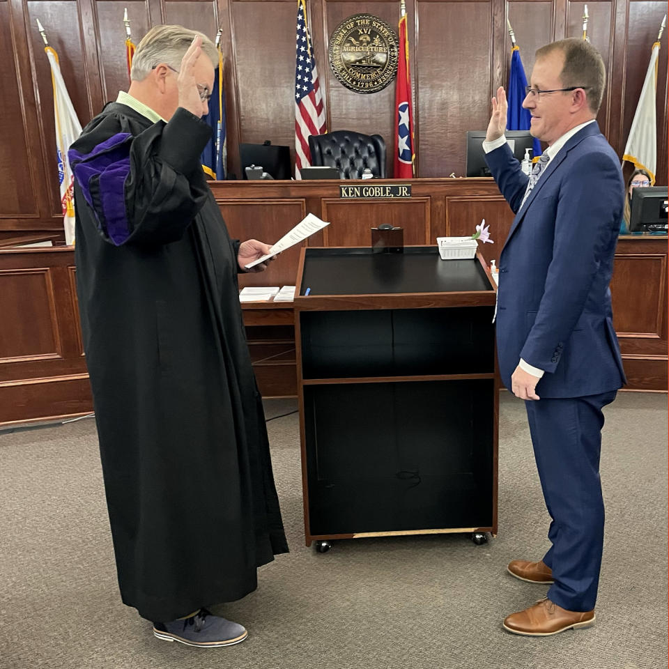 Image: Derek Scott is sworn in by a Judge in a courtoom. (Courtesy Derek Scott)