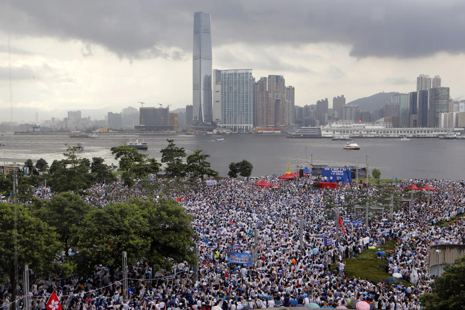 Pro-China's supporters hold Chinese flags and placards read "We support police" during a rally outside Legislative Council Complex in Hong Kong, Sunday, June 30, 2019. Supporters rallied in support of the police at Tamar Park (AP Photo/Kin Cheung)