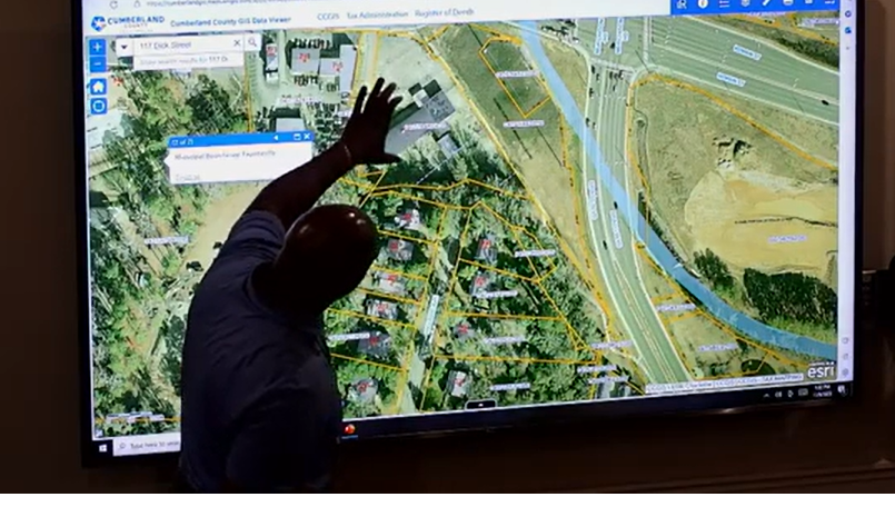 Michael Gibson, Fayetteville-Cumberland County Parks and Recreation directors, points on a map where the site of an international farmers market could be located in Fayetteville, near Bragg Boulevard, Murchison Road and Rowan Street, during a Nov. 9 commissioners' meeting.