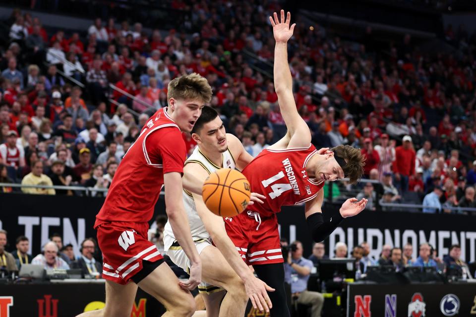 Wisconsin forwards Carter Gilmore (14) and Chris Hodges and Purdue center Zach Edey compete for the ball Saturday.