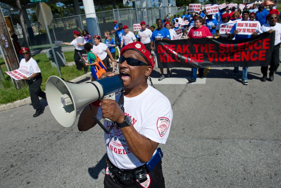 Ned Childress of the Guardian Angels leads a chant of 'Break the silence, stop the violence' while walking down Avenue M in Fort Pierce on Sept. 21, 2013. "We decided to form and organize this march to see if it will help curb some of the killing and shootings here in St. Lucie County,"  said Childress, who lead a group of several hundreds supporters on the three-mile march. "We decided on this march because we believe there is strength in numbers and this will help curb some of the shooting."