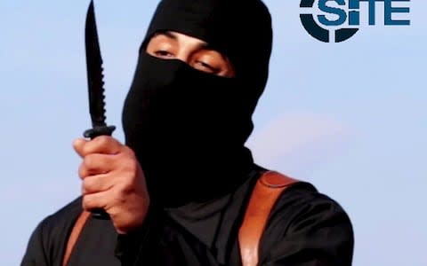 British Isil fighter Mohammed Emwazi brandishes a knife in this still file image from a 2014 video  - Credit: SITE